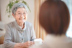笑顔でお茶を楽しむ入居者の女性